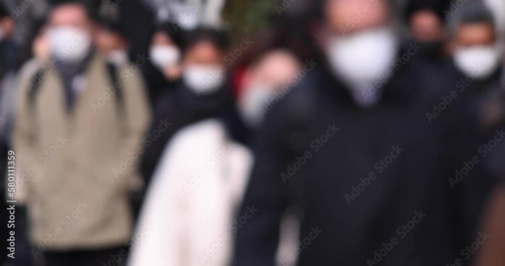 A crowd of walking people on the city street defocused A crowd of walking people on the city street defocused