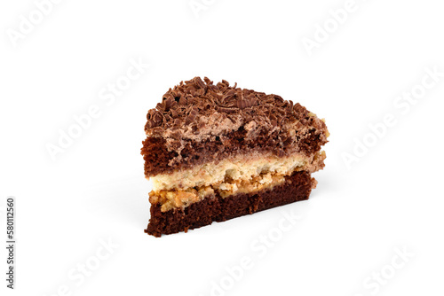 A slice of chocolate biscuit cake with layers of boiled condensed milk and meringue glazed chocolate cream and milk chocolate chips on a white background.