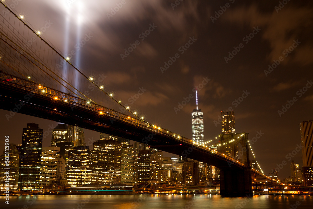 Brooklyn bridge with Tribute in Light . The installation of 88 searchlights has been displayed annually in remembrance of the September 11, 2001 attacks.