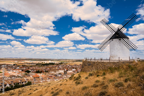 Windmill on the hill and in the background the village of Consuegra, Spain