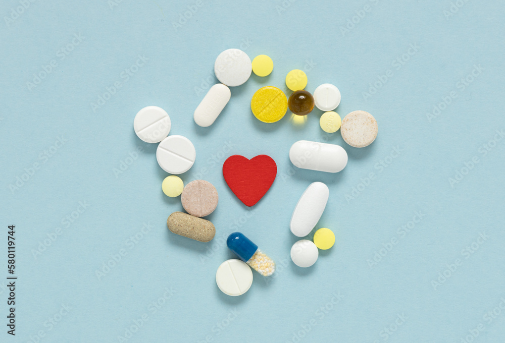 Different pills cardioglogy near red heart. Concept of heart diseases, problems with heart. Different pills cardioglogy near red heart. Concept of heart diseases, problems with heart.