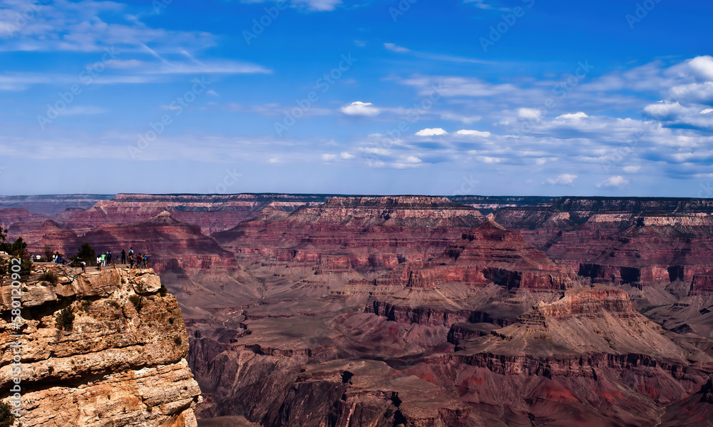 People standing at the rim of Grand Canyon. 