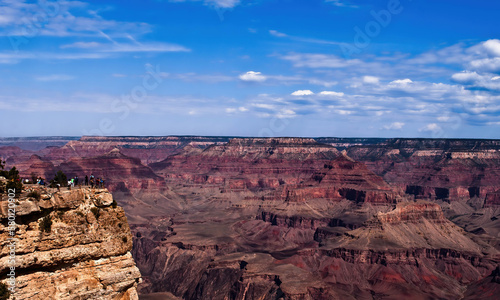 People standing at the rim of Grand Canyon. 