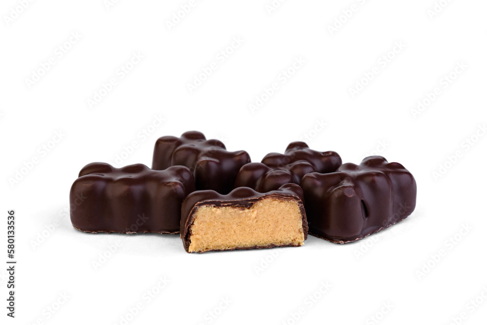 Pile of souffle candy in chocolate in the shape of a bear on a white background. Pile of souffle candy in chocolate in the shape of a bear on a white background.