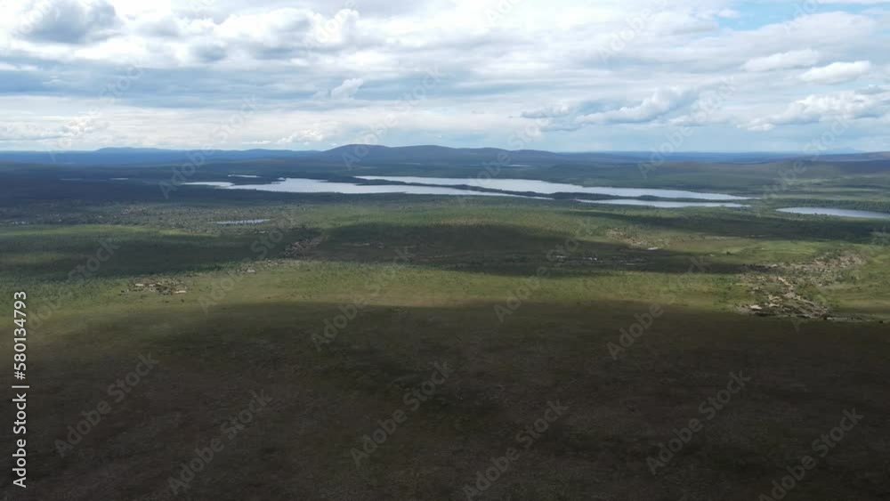 Flight over arctic bush wilderness with a lake in the background Flight over arctic bush wilderness with a lake in the background