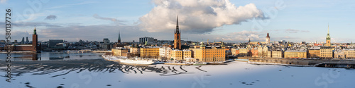 Panoramic view of Stockholm's most notable landmarks: old town, city hall and cathedral spires, sunny winter day