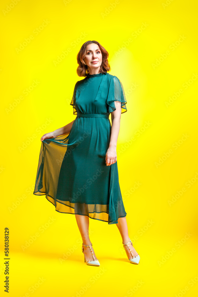 Elegant fashion. Stunning woman in elegant long dress in studio. Elegant fashion. Stunning woman in elegant long dress in studio.