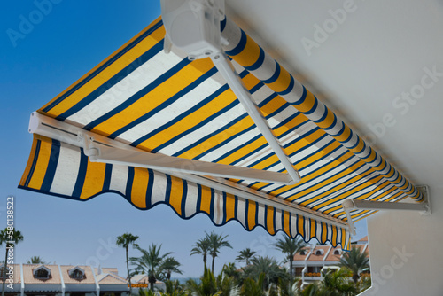 Canvastavla retractable manual awning above apartment balcony