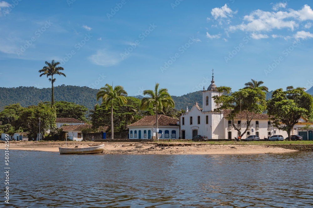 Paraty, Brazil. Our Lady of Sorrows church seen from the sea. Historic downtown. Colonial city founded in 1667. National Historic Heritage. In the background, the mountains of Serra da Bocaina.