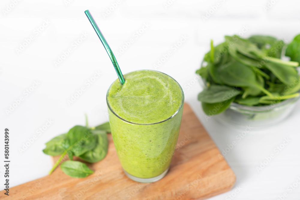 Fototapeta premium Healthy green smoothie and ingredients on white - spinach, apple and kiwi. detox and healthy food.