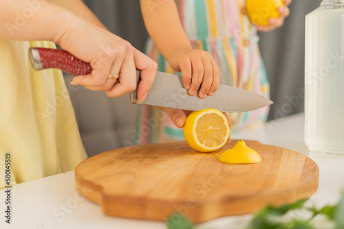 Hands of woman cutting lemons