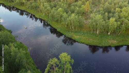 Flying across a wilderness river in Lapland, Finland