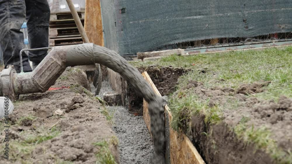 concreting of the foundation of the new building. pouring concrete into an excavation in the ground concreting of the foundation of the new building. pouring concrete into an excavation in the ground