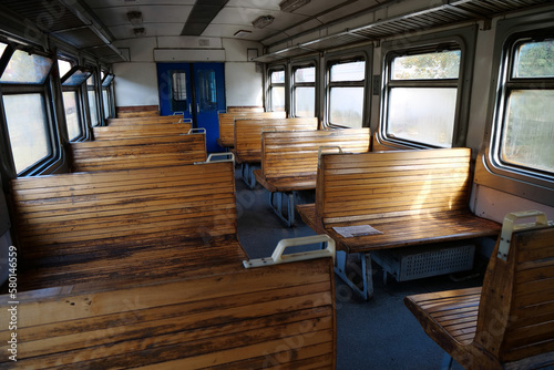 Old empty wagon of train. Wooden seats in an empty coach of train