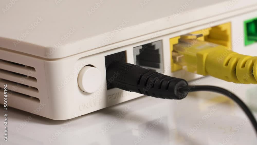 Man's hand turns on the Internet modem. Router Man's hand turns on the Internet modem. Router