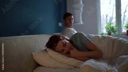 Upset young woman thinking of breakup or divorce while lying in bed with husband, feeling sad and frustrated after fight with boyfriend. Unhappy married couple not talking after quarrel. Family crisis
