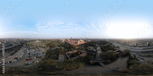 An aerial 360-degree panorama of historic Badshahi Mosque, Minar-e-Pakistan, and Aazadi Chowk Flyover; captured at dusk with a drone. 