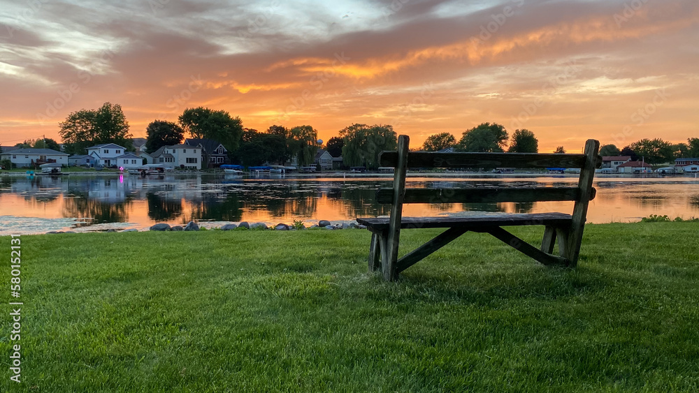 bench next to the river at colorful sunset