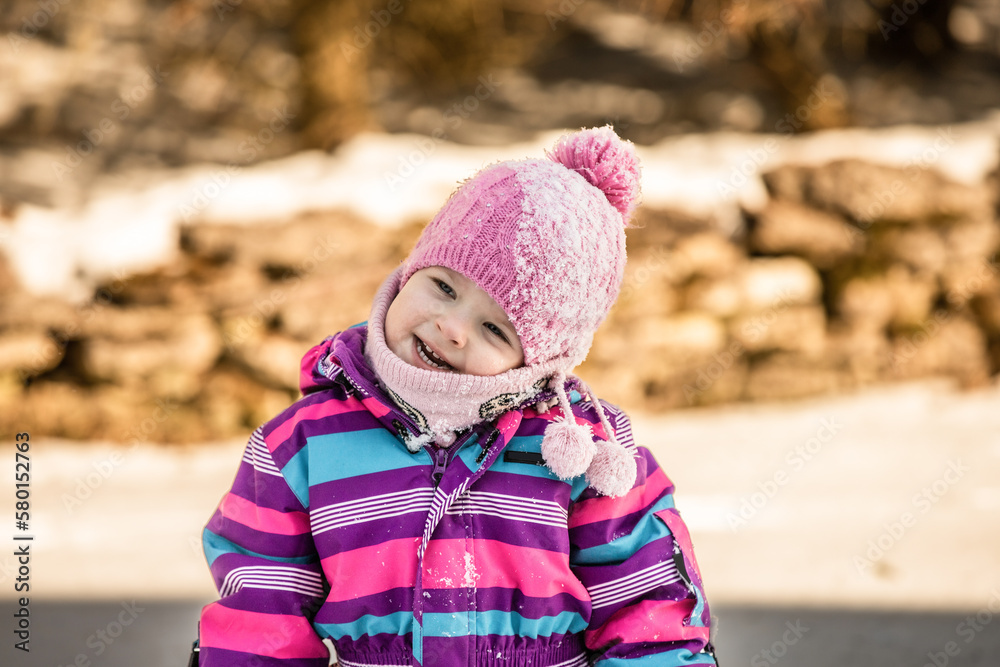 A little girl enjoys the sunny and cold winter wonderland of the north. A little girl enjoys the sunny and cold winter wonderland of the north.
