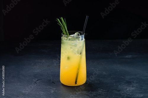 Orange cocktail with ice and rozemary, orange lemonade. photo