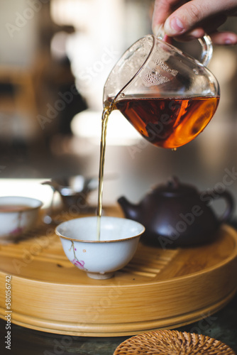 Chinese traditional tea ceremony. Tea is pouring from the teapot