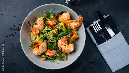 Salad with shrimp tempura, sweet pepper, spinach and microgreens.