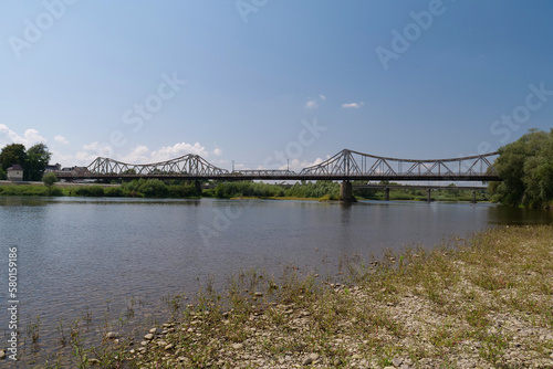 Old metal bridge across Dniester river in the city of Halych, western Ukraine photo