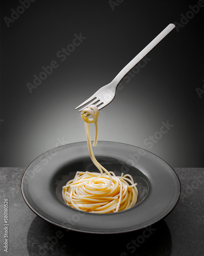 Flying fork with spagetti photo