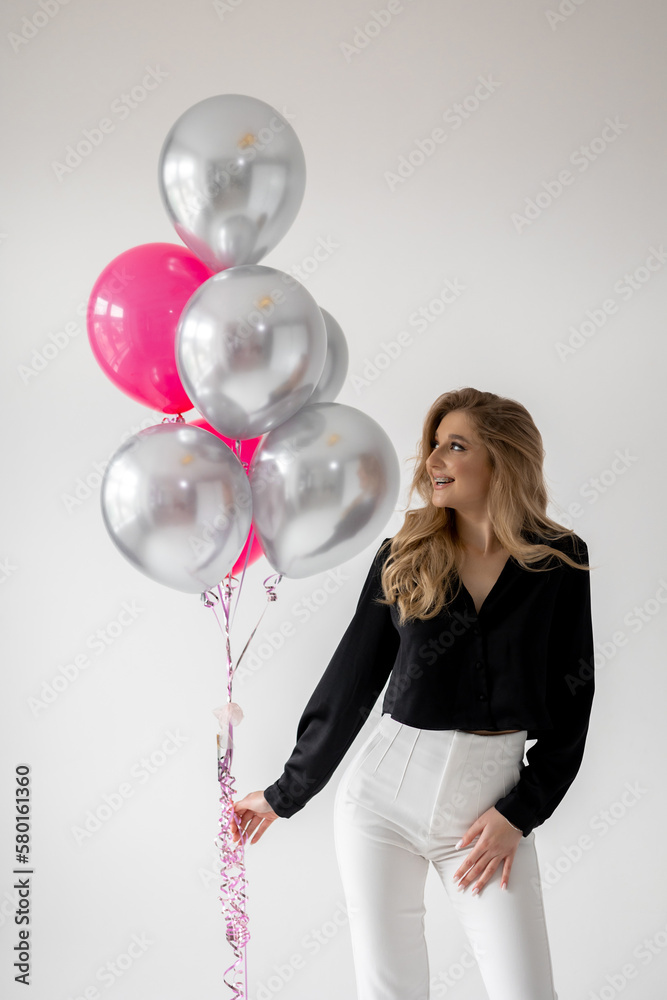 Smiling blonde woman with balloons isolated on white. Girl with braces. Orthodontics treatment. Smiling blonde woman with balloons isolated on white. Girl with braces. Orthodontics treatment.