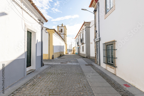 a cobbled street with typical white houses in Alcáçovas, municipality of Viana do Alentejo, District of Evora, Alentejo, Portugal - December 2022 photo