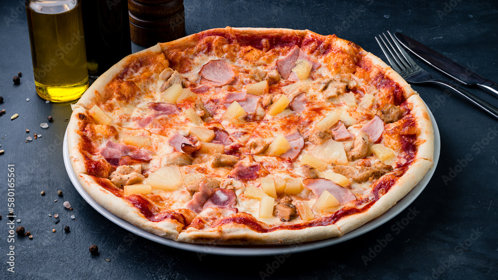 Italian food pizza with chicken, ham, cheese, pineapple and tomato sauce.