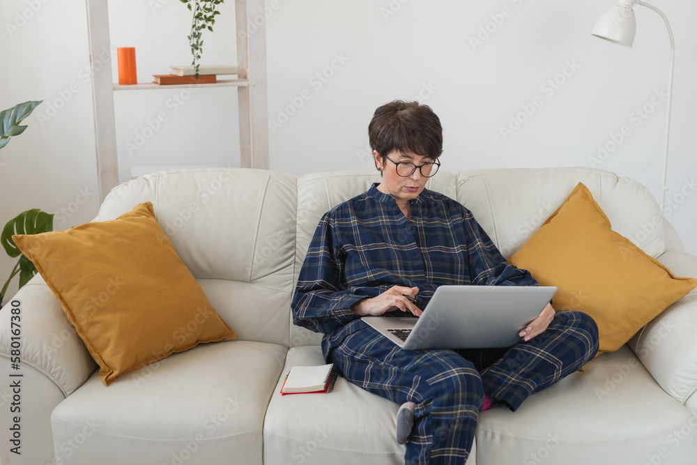 Businesswoman or blogger working on laptop computer sitting at home and managing her business via home office during coronavirus or Covid-19 lockdown. Remote work and blogging concept Businesswoman or blogger working on laptop computer sitting at home and managing her business via home office during coronavirus or Covid-19 lockdown. Remote work and blogging concept