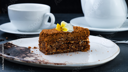 Piece of honey chocolate cake on plate.