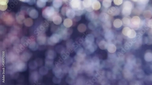 Abstract background with flickering and glittering silver colorful metallic particles or sequins on the wall, unfocused, bokeh