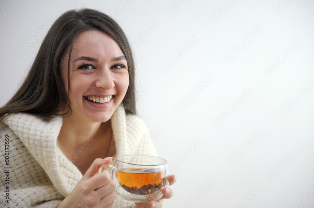 young woman girl in plaid drinks black tea in a glass double glass brew tea space for text rest after sauna relaxation relaxation recovery joy frozen thawing young woman girl in plaid drinks black tea in a glass double glass brew tea space for text rest after sauna relaxation relaxation recovery joy frozen thawing
