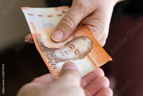 Chile 20 thousand pesos, banknote, Passing money from hand to hand, Financial and business concept, Chile's highest denomination banknote, Passing cash to each other
