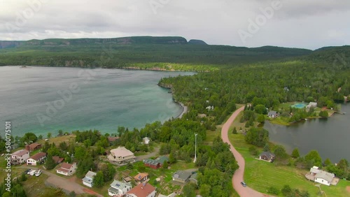 Aerial view of blue water Lake Superior with green Canadian coastline Sleeping Giant Silver Islet Evergreen Trees Mountain Cliffs in background