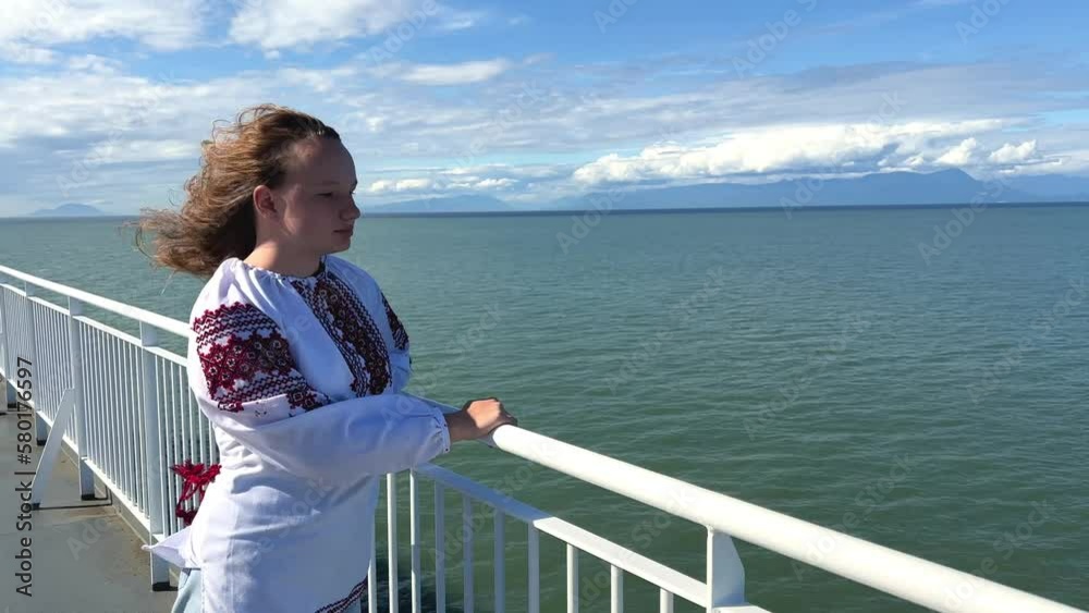 Ocean sea girl is standing alone on liner and is very happy she is returning home she fled from Ukraine war Now Ukraine has won she can return home to her parents IDPs and refugees return to Ukraine Ocean sea girl is standing alone on liner and is very happy she is returning home she fled from Ukraine war Now Ukraine has won she can return home to her parents IDPs and refugees return to Ukraine