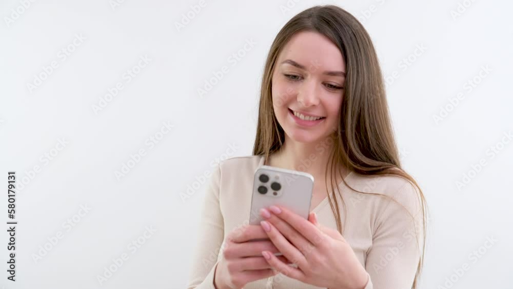 girl in hands of smartphone white phone girl smiling good news beautiful video interesting information social networks white background studio life on Internet life priorities place for text ad girl in hands of smartphone white phone girl smiling good news beautiful video interesting information social networks white background studio life on Internet life priorities place for text ad