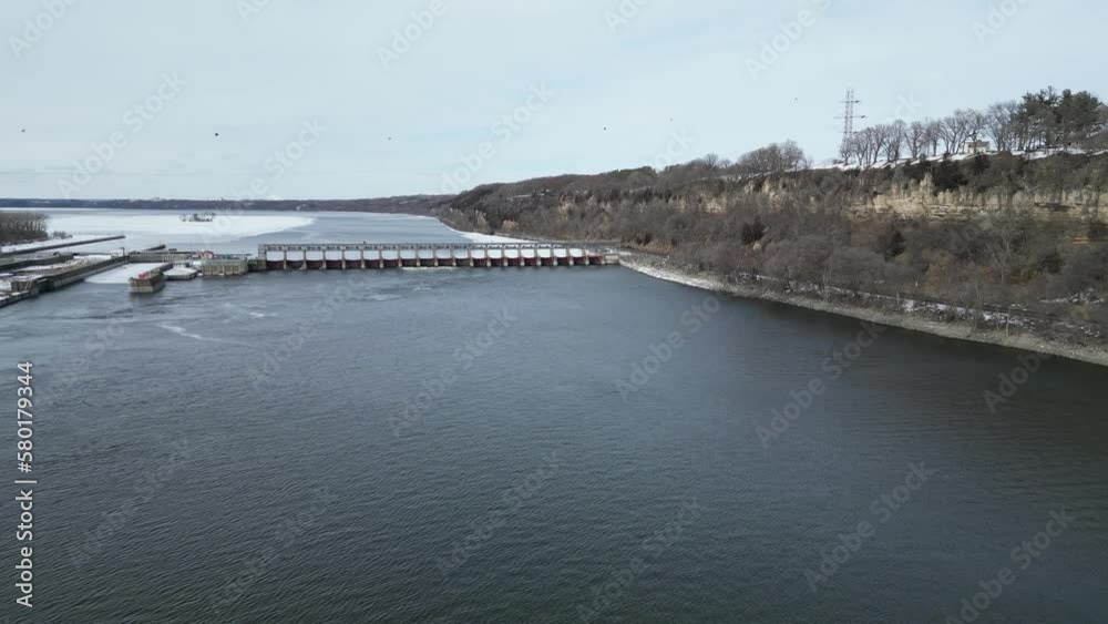Flying over the Mississippi River towards a hydroelectric dam in the Minnesota winter Flying over the Mississippi River towards a hydroelectric dam in the Minnesota winter