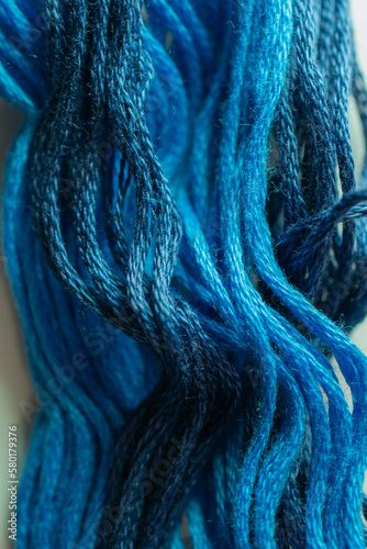 Waves of blue thread bring to mind swells of the ocean or shades storm clouds.