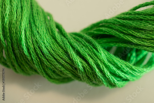 A textured twist of green thread brings to mind crafts of knitting, embroidery, and sewing. photo