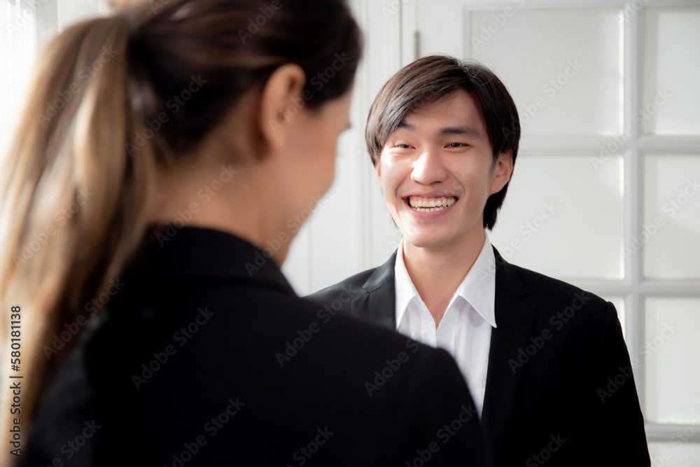 Young manager standing and talking with secretary about report marketing on digital tablet with relax and laughing at office, colleague discussion with friendship together, business concept. Young manager standing and talking with secretary about report marketing on digital tablet with relax and laughing at office, colleague discussion with friendship together, business concept.