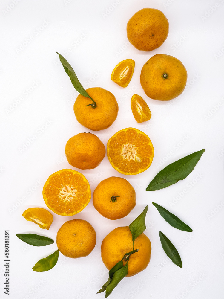 Orange fruit with green leaves on the white background. Home gardening. Mandarine oranges. Tangerine oranges. Orange color. Fresh orange juice. Orange fruit with green leaves on the white background. Home gardening. Mandarine oranges. Tangerine oranges. Orange color. Fresh orange juice.