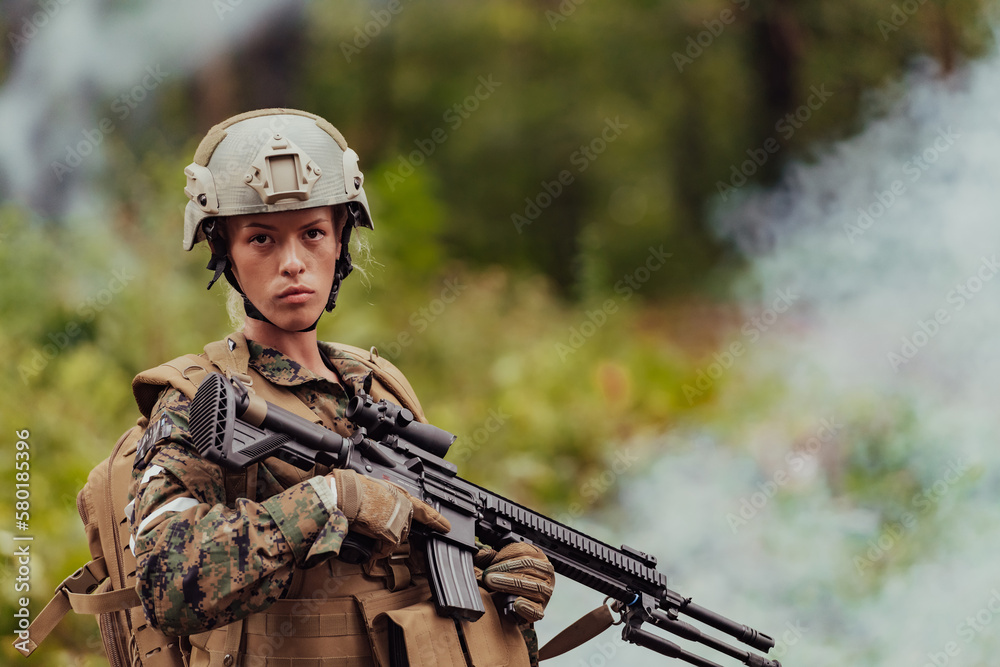 Fototapeta premium Woman soldier ready for battle wearing protective military gear and weapon