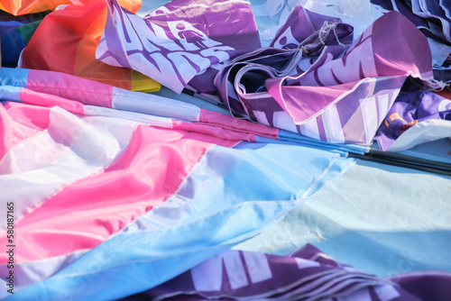 Flags of the trans community next to purple feminist flags of the cause Ni una menos, Not a single one less. Transgender inclusive feminism. 