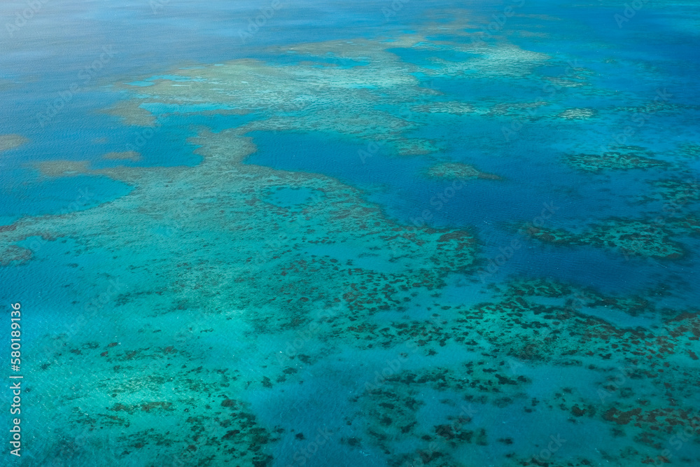An aerial view of the coral reefs, white sand bars, tropical isles and clear turquoise waters of the Great Barrier Reef — Coral Sea, Cairns; Far North Queensland, Australia