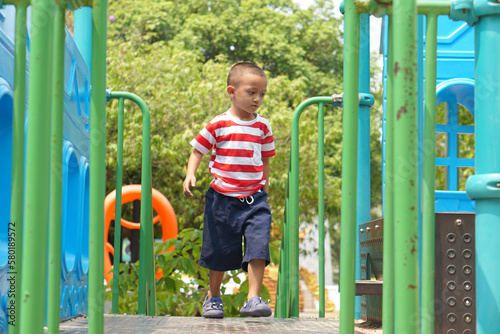 boy playing in the playground in the park