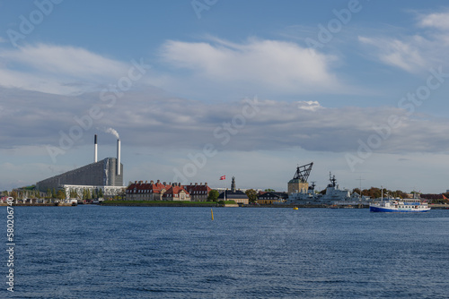 Outdoor exterior view  cityscape along waterfront and background of The historic warships on Holmen,The floating museum of Copenhagen at Nyholm and CopenHill. photo
