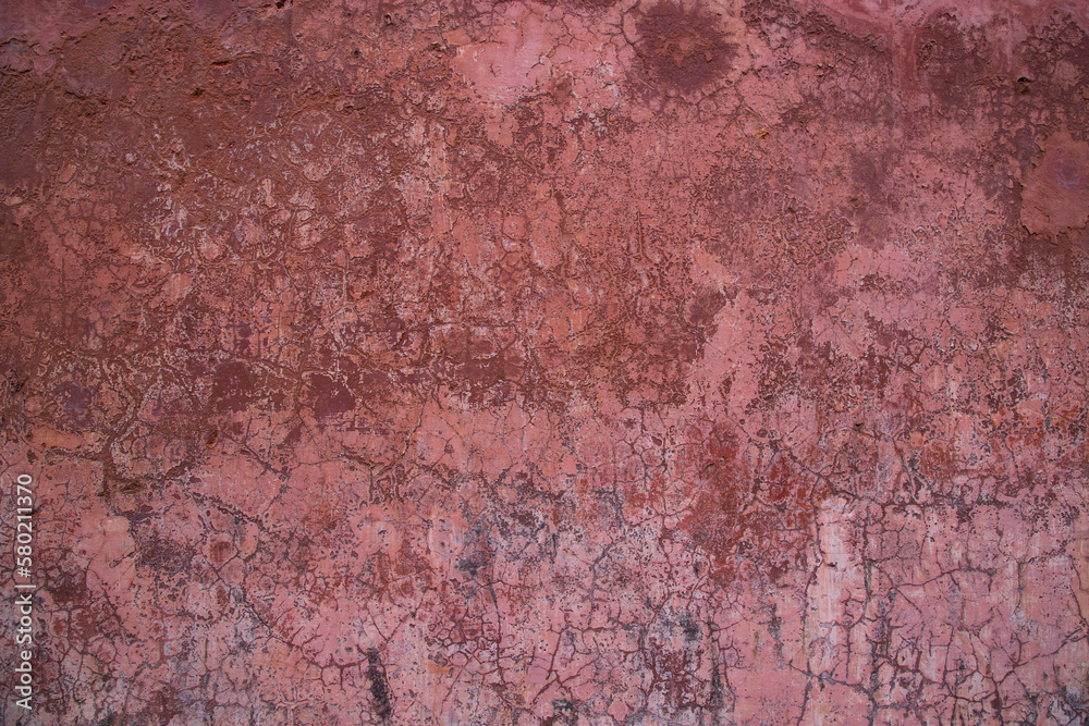 The texture of an old rustic wall is covered with pink stucco